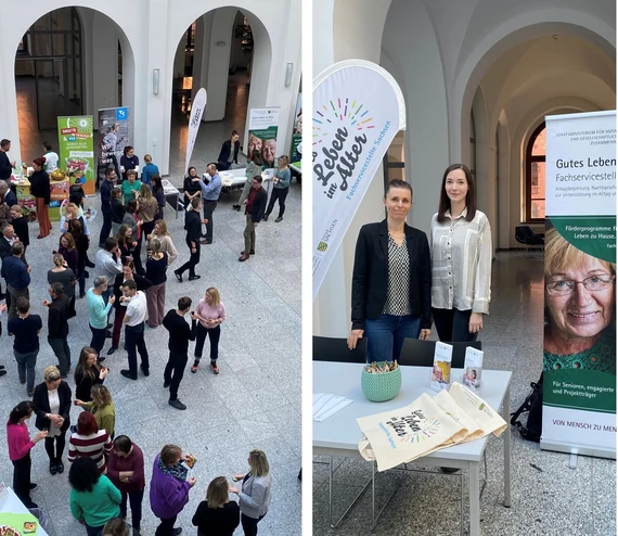 Gesundheitstag: Teilnehmende in Eingangshalle, rechts zwei Mitarbeiterinnen am Stand "Gutes Leben im Alter" mit Materialien.